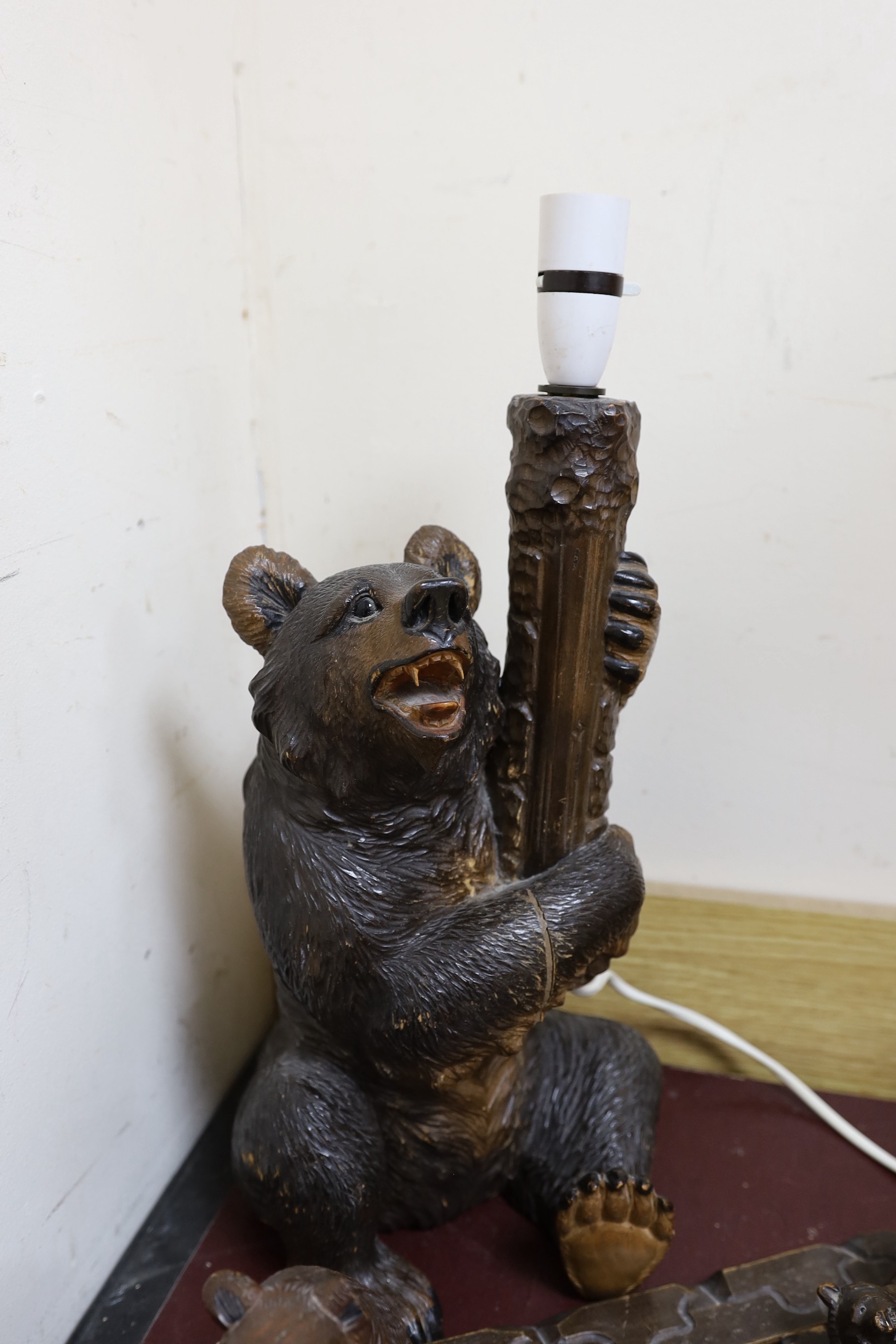 A group of Black Forest carved wood bears: a lamp, a book rack, etc.